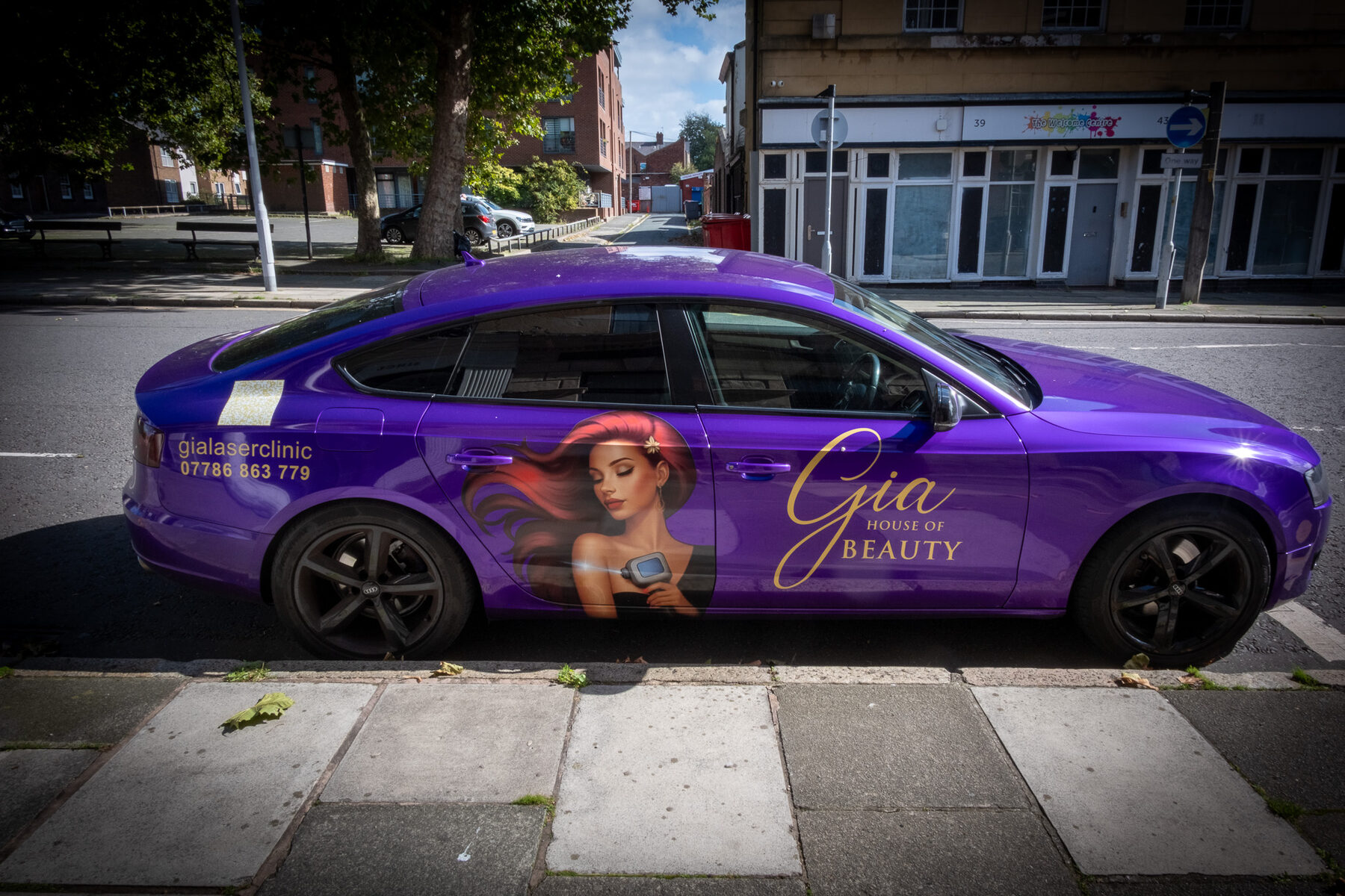 Purple beauty clinic branded car parked on the street
