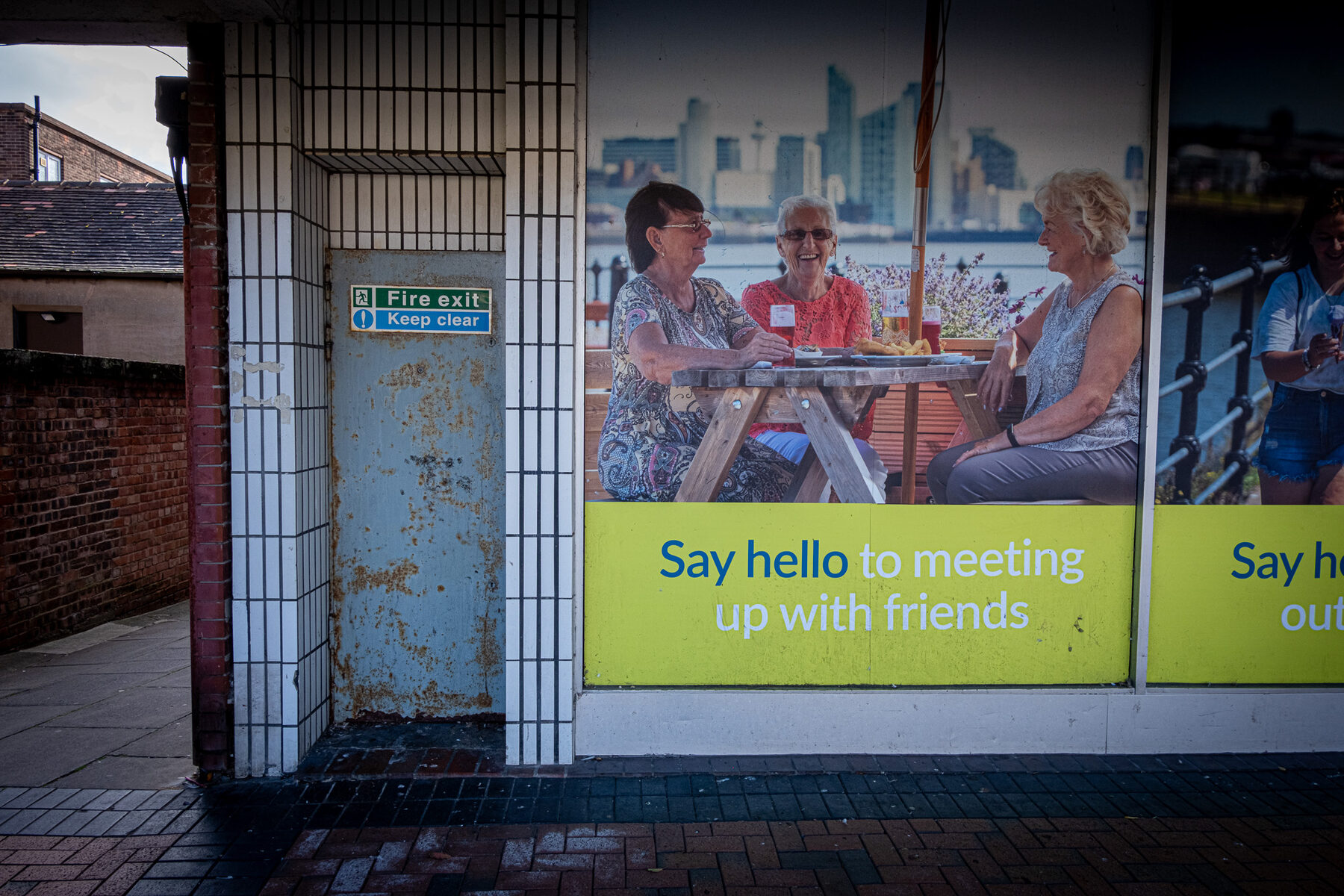 Advertising poster of retired friends next to a rusted door