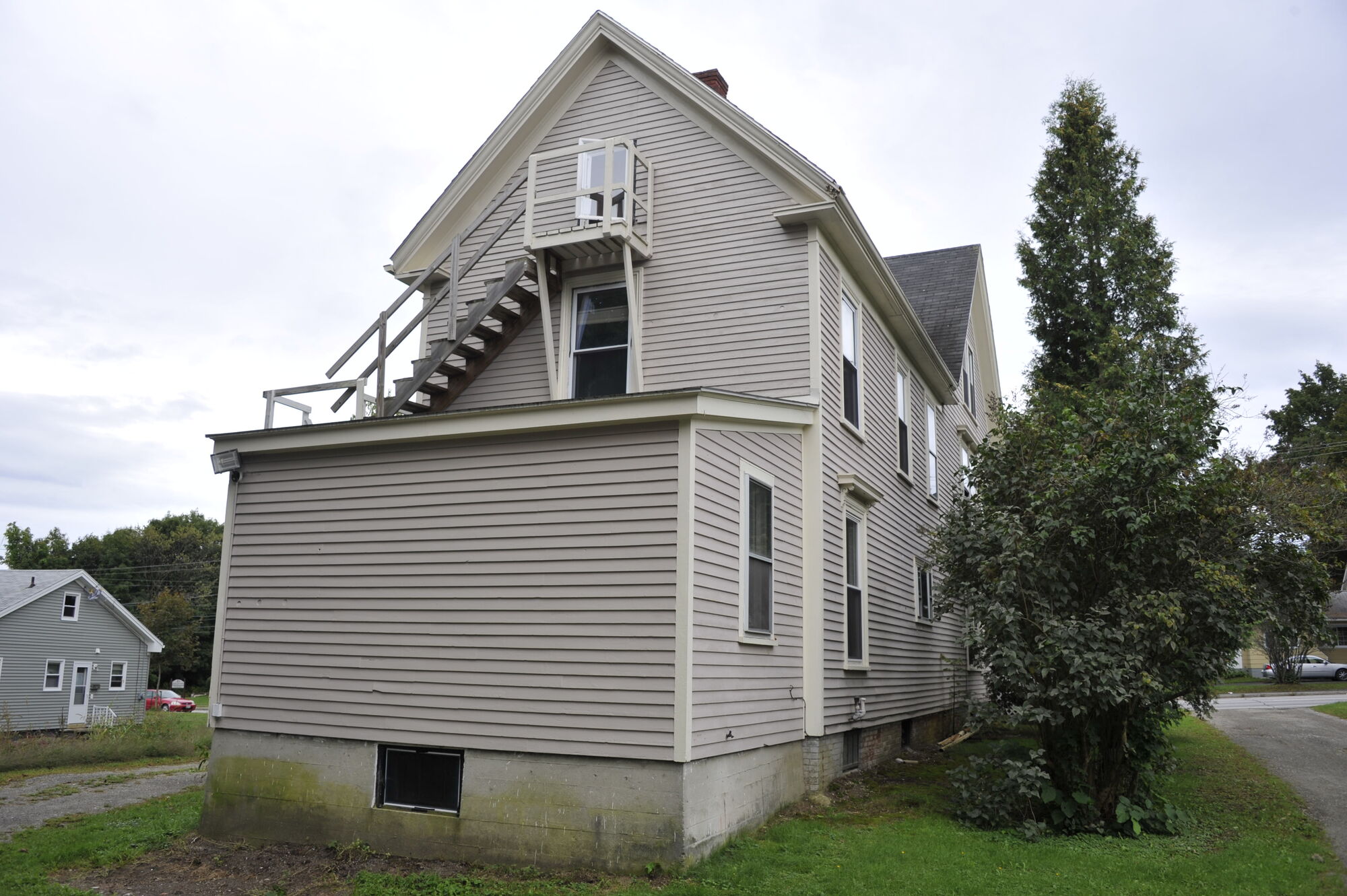 Side elevation of the clapboard house with outside staircase